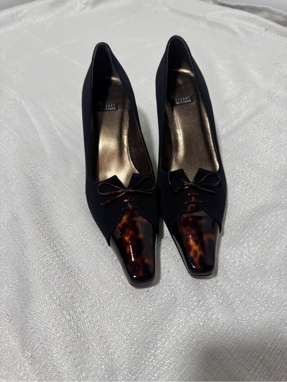 Elegant Stuart Weitzman heels in a classic black with unique tortoise shell cap